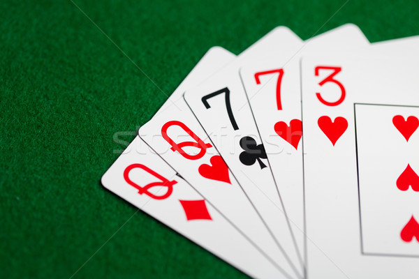 poker hand of playing cards on green casino cloth Stock photo © dolgachov