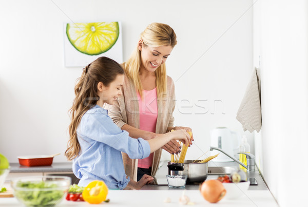 happy family cooking food at home kitchen Stock photo © dolgachov