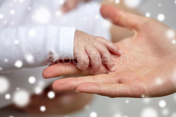 Stock photo: close up of mother and newborn baby hands