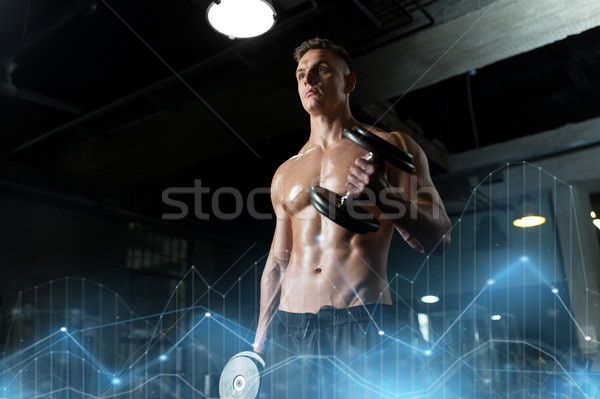 close up of man with dumbbells exercising in gym Stock photo © dolgachov
