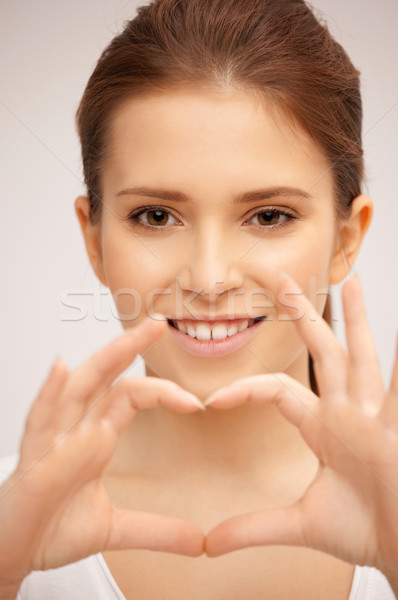 happy woman making heart gesture Stock photo © dolgachov