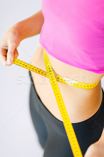 trained belly with measuring tape Stock photo © dolgachov