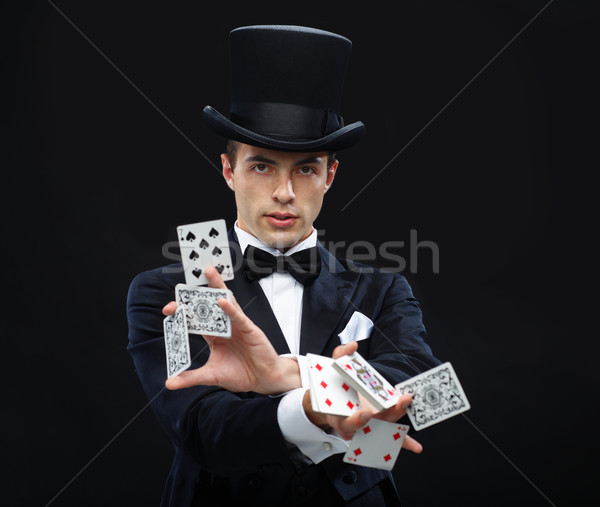 magician showing trick with playing cards Stock photo © dolgachov