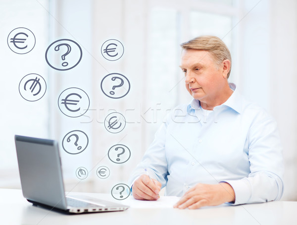 old man with laptop filling a form at home Stock photo © dolgachov