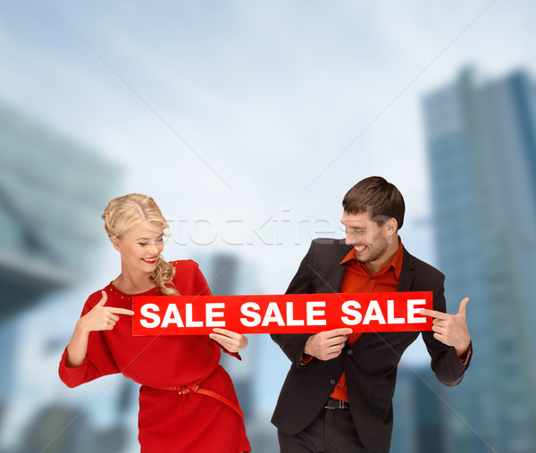 smiling woman and man with red sale sign Stock photo © dolgachov