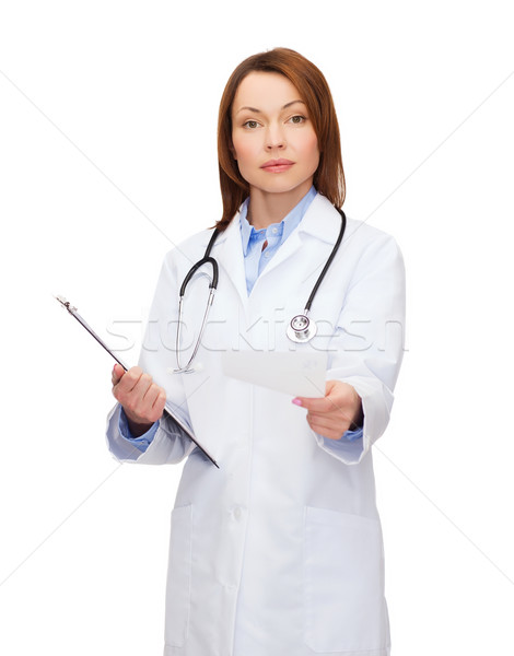 calm female doctor with clipboard Stock photo © dolgachov