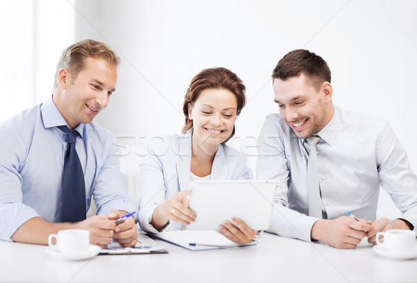 business team looking at tablet pc in office Stock photo © dolgachov