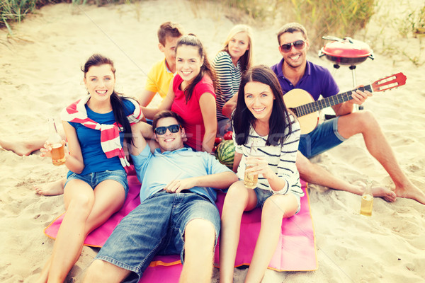 group of friends with guitar having fun on beach Stock photo © dolgachov