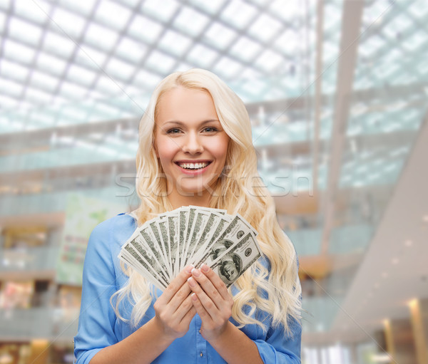 smiling young woman with us dollar money Stock photo © dolgachov