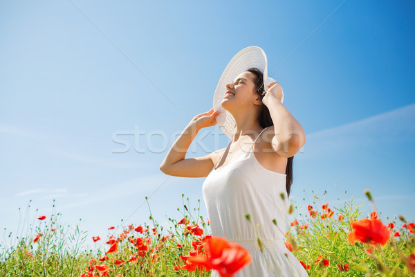 Sorridente mulher jovem chapéu de palha papoula campo felicidade Foto stock © dolgachov