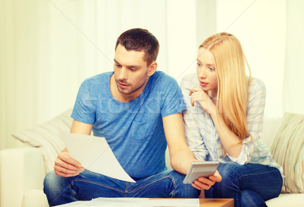 busy couple with papers and calculator at home Stock photo © dolgachov