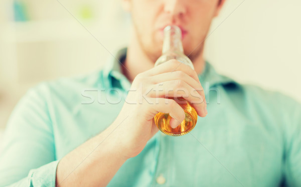 close up of man drinking beer at home Stock photo © dolgachov