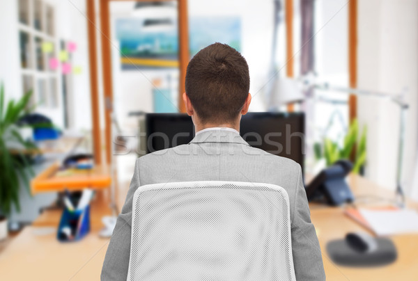 businessman sitting in office chair from back Stock photo © dolgachov