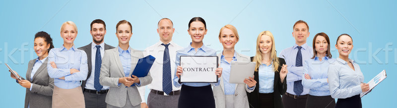 Stock photo: group of happy businesspeople holding contract