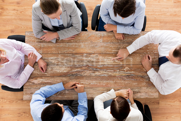 close up of business team sitting at table Stock photo © dolgachov