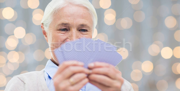 close up of happy senior woman playing cards Stock photo © dolgachov