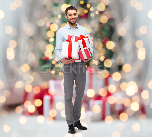 Feliz hombre cajas de regalo Navidad luces Foto stock © dolgachov