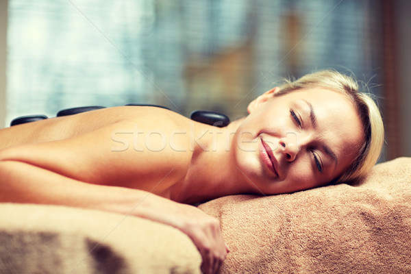 close up of woman having hot stone massage in spa Stock photo © dolgachov