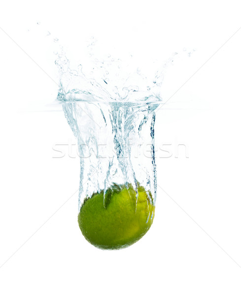 lime falling or dipping in water with splash Stock photo © dolgachov