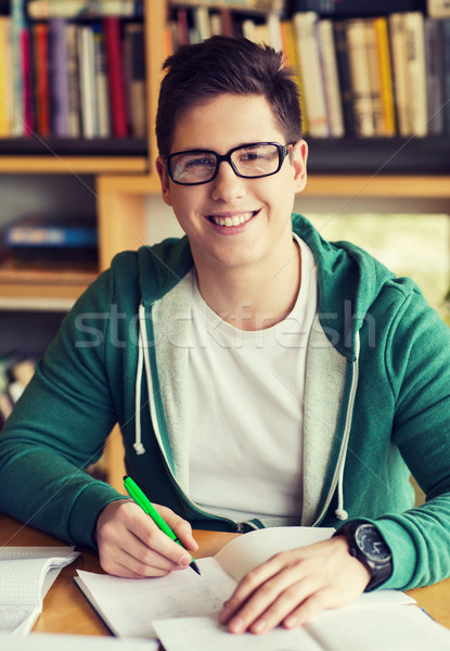 Heureux étudiant écrit portable bibliothèque personnes [[stock_photo]] © dolgachov