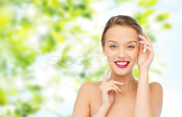 smiling young woman with pink lipstick on lips Stock photo © dolgachov