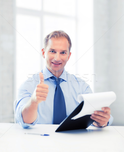 businessman with papers showing thumbs up Stock photo © dolgachov
