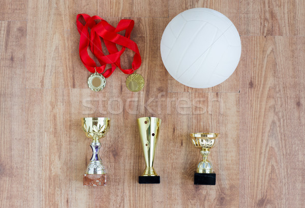 close up of volleyball ball, cups and medals Stock photo © dolgachov