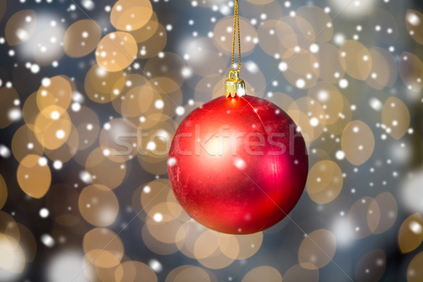 close up of red christmas ball over golden lights Stock photo © dolgachov