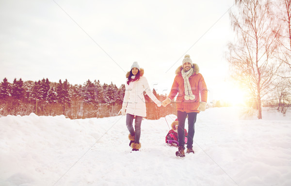 happy family with sled walking in winter outdoors Stock photo © dolgachov