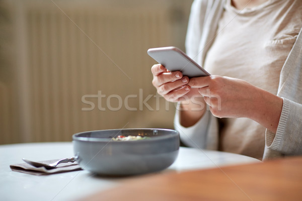 woman with smartphone photographing food at cafe Stock photo © dolgachov