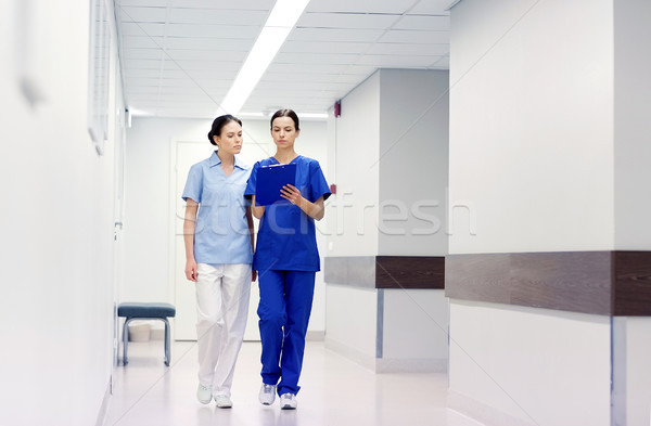 two medics or nurses at hospital with clipboard Stock photo © dolgachov