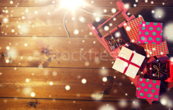 close up of christmas gift boxes on wooden sleigh Stock photo © dolgachov