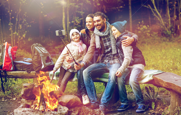 family with smartphone taking selfie near campfire Stock photo © dolgachov