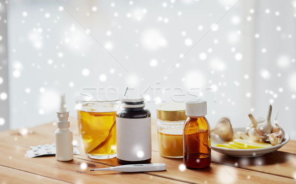 drugs, thermometer, honey and cup of tea on wood Stock photo © dolgachov