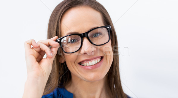 close up of smiling middle aged woman in glasses Stock photo © dolgachov