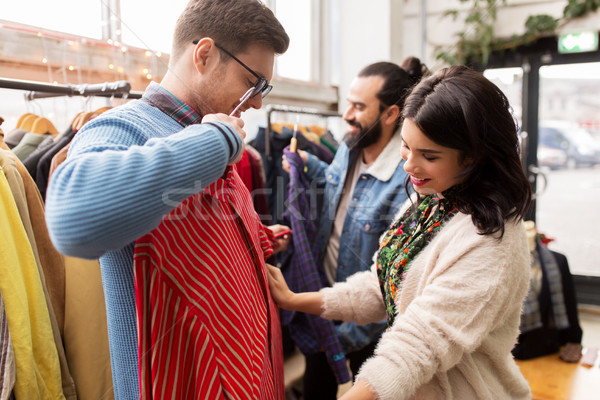 friends choosing clothes at vintage clothing store Stock photo © dolgachov