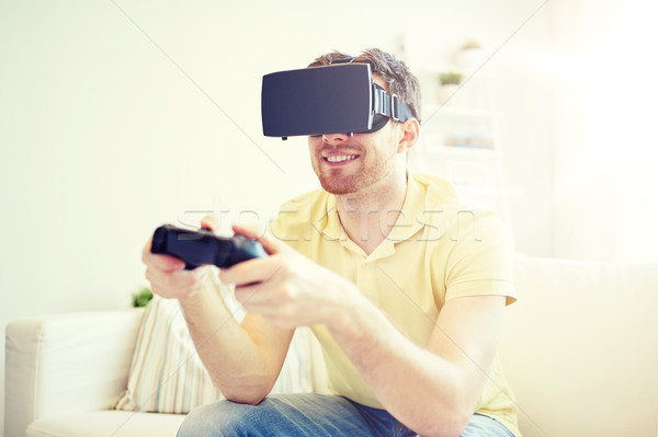 man in virtual reality headset with controller Stock photo © dolgachov