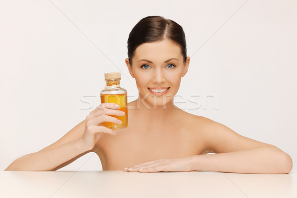 woman with oil bottle Stock photo © dolgachov