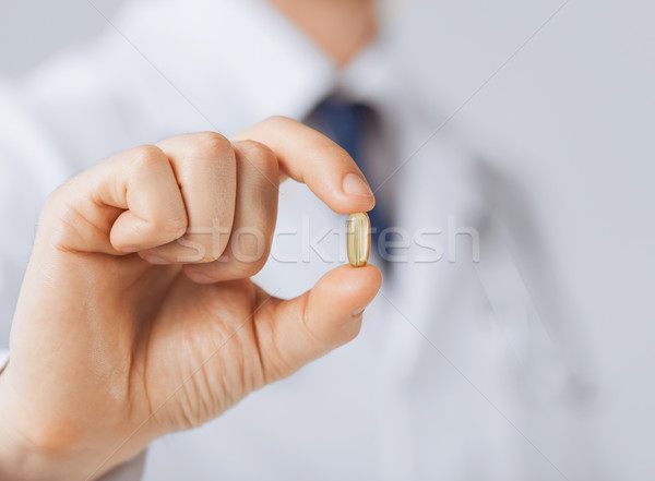 Orvos kéz mutat egy kapszula kép Stock fotó © dolgachov