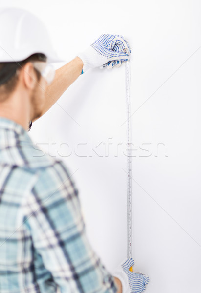 architect measuring wall with flexible ruler Stock photo © dolgachov