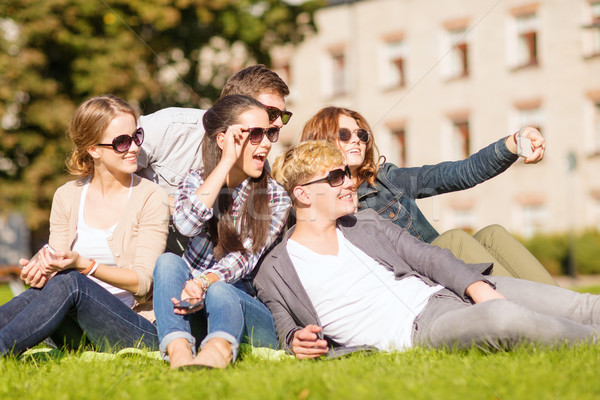 teenagers taking photo outside with smartphone Stock photo © dolgachov