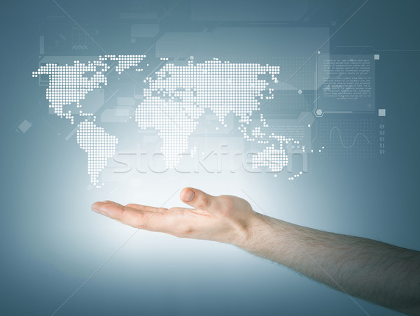 mans hand showing world map Stock photo © dolgachov