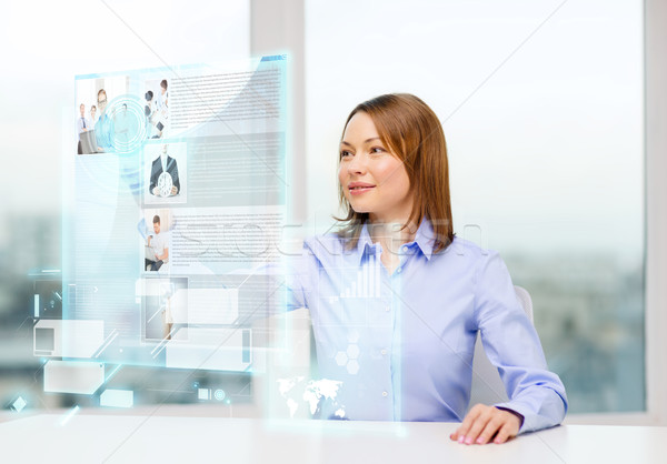 smiling woman pointing to news on virtual screen Stock photo © dolgachov