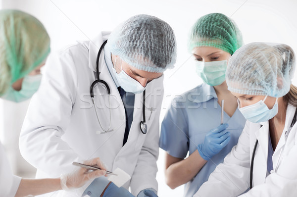 young group of doctors doing operation Stock photo © dolgachov