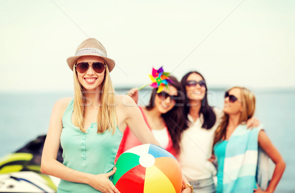 girl with ball and friends on the beach Stock photo © dolgachov