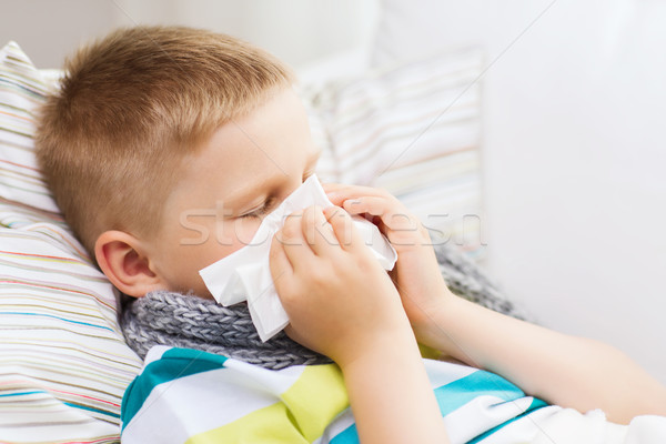 ill boy with flu at home Stock photo © dolgachov