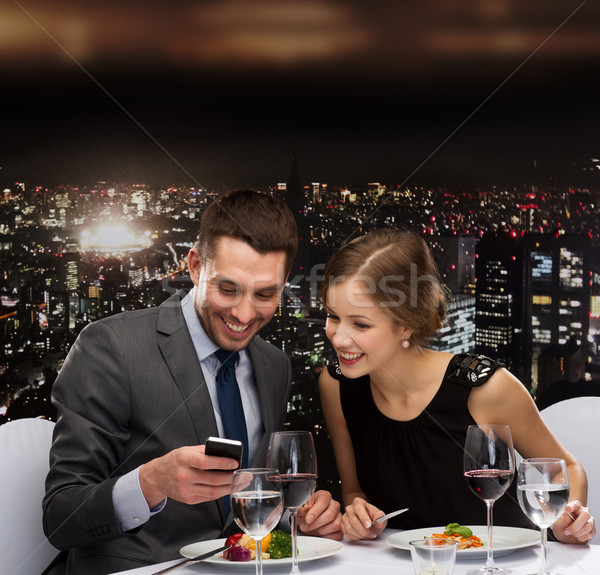smiling couple eating main course at restaurant Stock photo © dolgachov
