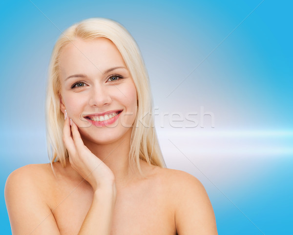 Uśmiechnięty młoda kobieta dotknąć twarz skóry zdrowia Zdjęcia stock © dolgachov