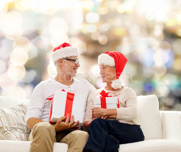 happy senior couple in santa hats with gift boxes Stock photo © dolgachov