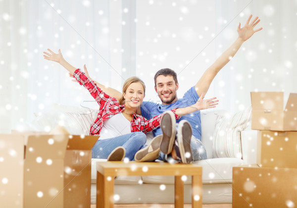smiling couple relaxing and waving hand at home Stock photo © dolgachov